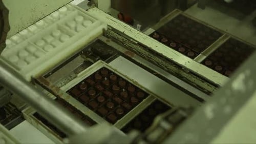 candy molds are separated from a package of chocolates in a chocolate factory