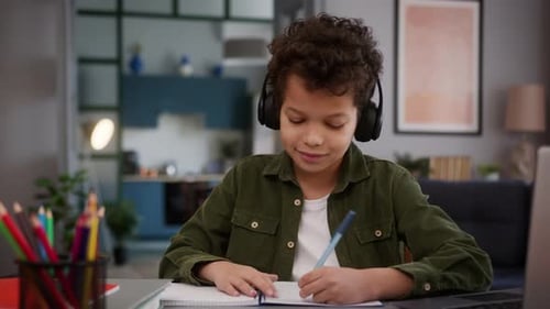 Boy Studying at Home Wearing Headphones