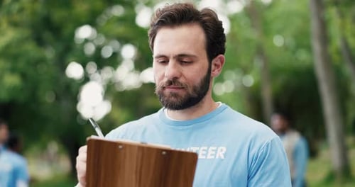 Clipboard, man and volunteer outdoor with planning for social responsibility, ngo or charity event
