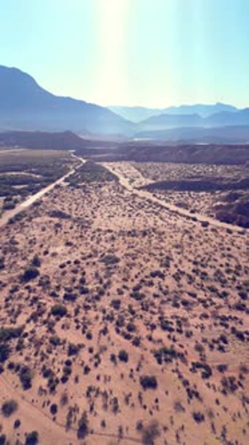 Vertical video of an Aerial view drone flying over scenic red rocky mountains landscape with a clear