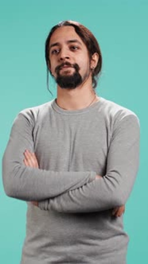 Confident Man Smiling with Arms Crossed Studio Portrait