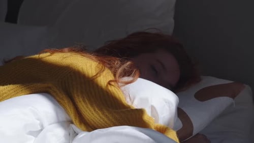 Woman Sleeps Peacefully in Bed Daytime