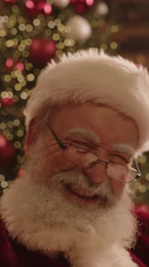 Smiling Person with White Beard Wearing Christmas Outfit