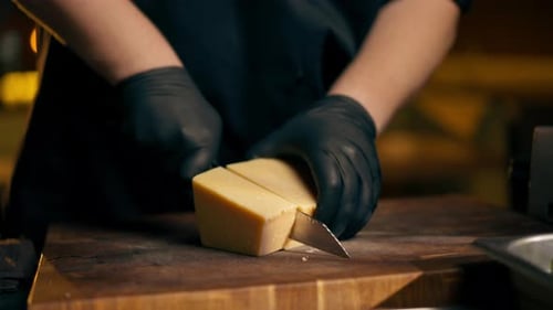 Close Up in a Restaurant in Rib Bar in the Central Hall with Yellow Lighting a Chef in Black Gloves