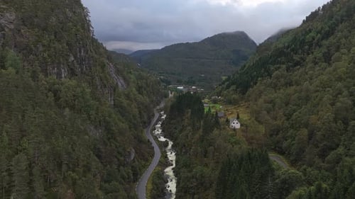 Aerial view of mountain waterfall flowing in remote Norway valley