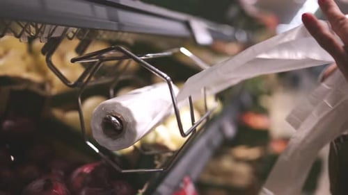 Mujer lleva bolsas de plástico desechables para las verduras