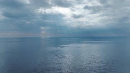 Aerial Video Perspective of Clouds Over the Sea with Stunning Water Reflections