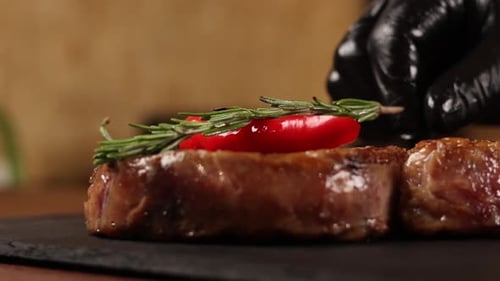 Chef cooks meat on the grill