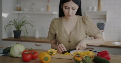 Woman Preparing Healthy Salad in Bright Kitchen