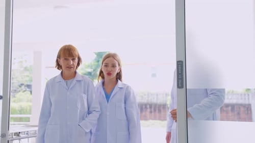 Caucasian team of doctors walking with confidence into the hospital.