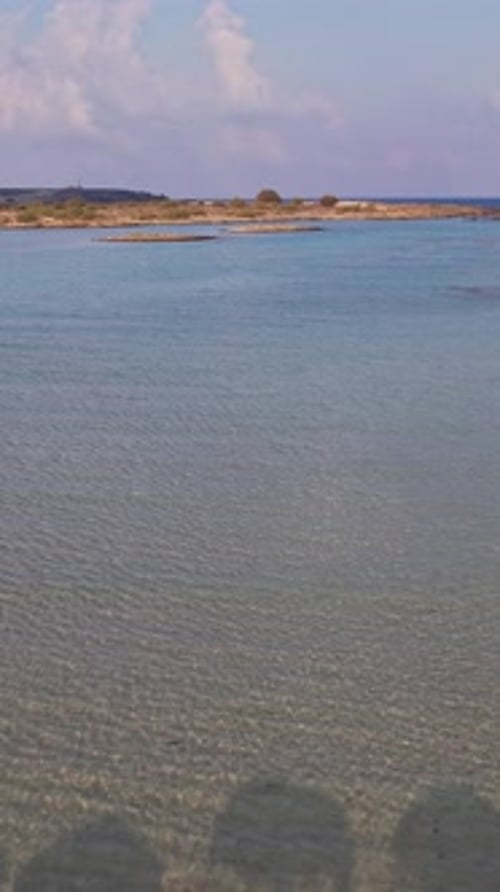 Tranquil beach with straw umbrellas and calm waters in sunny weather