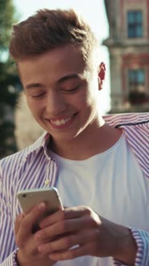 Close Up Face Young Happy Man Walk on Street Use Phone Look Around Smile Sunlight Cute Work Mobile