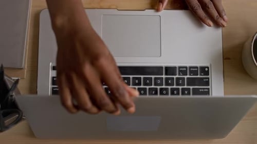 Opening Laptop and Typing in Bright Office Space