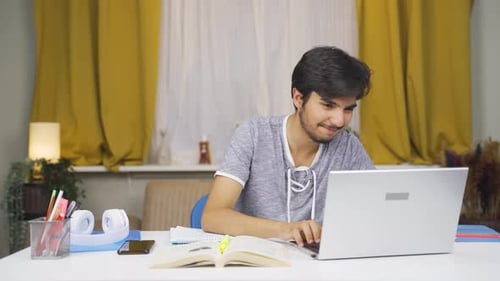 Young Adult Studying on Laptop At Home