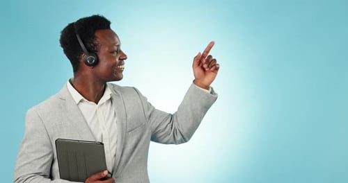 Smiling Man in Suit Points with Tablet