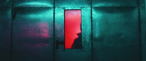 Silhouette of a Killer behind a Door