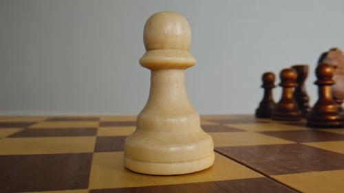 Wooden White Pawn Standing on Chessboard Closeup Brown Chess Pieces Blurred