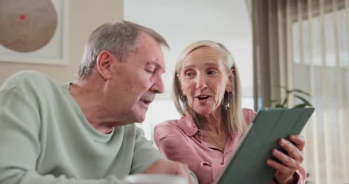 Happy Senior Couple Using Tablet at Home