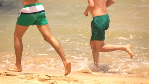 Two Men Running On Beach Near Sea, Super Slow Motion 240fps