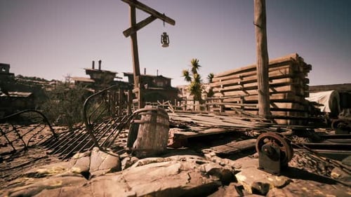Desolate Old Mining Town with Wooden Structures Under Bright Midday Sun