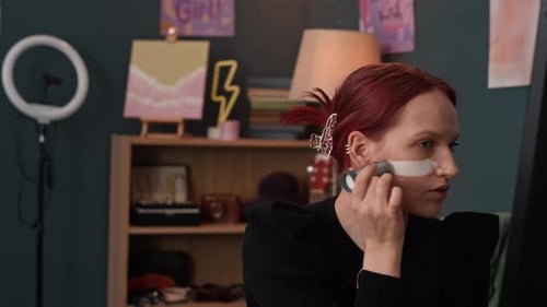 Portrait of Gen Z Girl with Red Hair Applying Makeup in front of Mirror