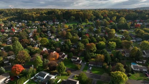 American town in autumn. Colorful fall foliage in residential suburban housing development. Homes in
