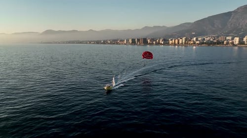 Parasailing Over the Sea at the Most Beautiful Sunset Hour