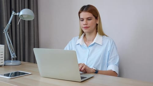 Happiness young businesswoman using laptop computer on desk in living room at home office.