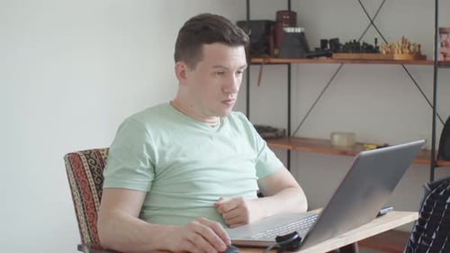 Young Man Freelancer Using Laptop Studying Online Working From Home Happy Casual Millennial Guy