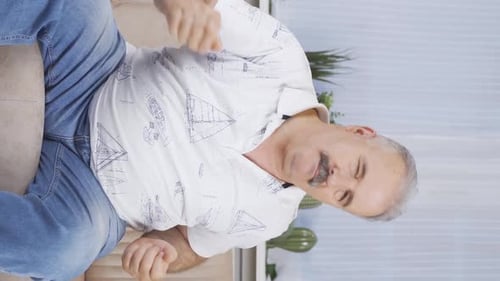 Vertical video of Happy old man dancing to the camera.
