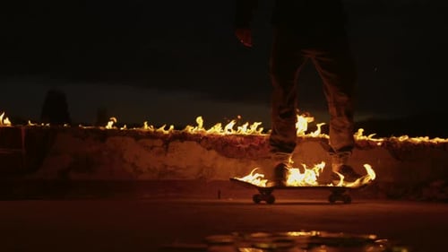 Man on Burning Skateboard During Night