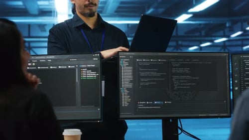 Manager in Data Center Doing Annual System Review Checking Parameters on Laptop