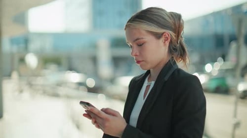 Young Woman Using Smartphone in Urban Setting