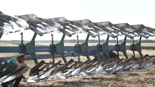 Tractors plowing the field in Ukraine