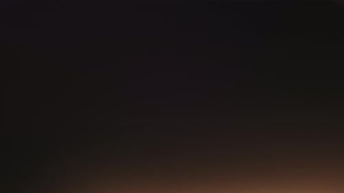 Abstract Overlay with Flashing Low Light Transition Lens Flare Effects on Dark Background Anamorphic