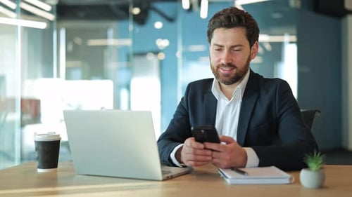 Happy Business Professional Using Smartphone in Modern Office