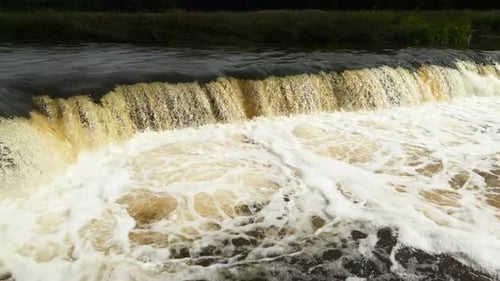 Falls in the River From Above Aerial Shot Showcases the Captivating Allure of a Waterfall Within a