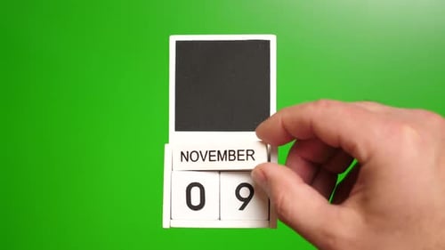 Hand Changing the Date to November Ninth