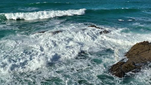 Slow Motion Of Bubbling Blue Ocean Water With White Foam Surfaces.
