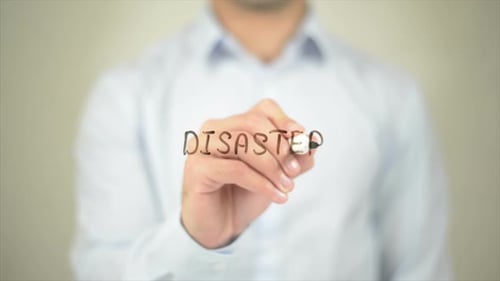 Man Writes Disaster with Marker on Glass Surface