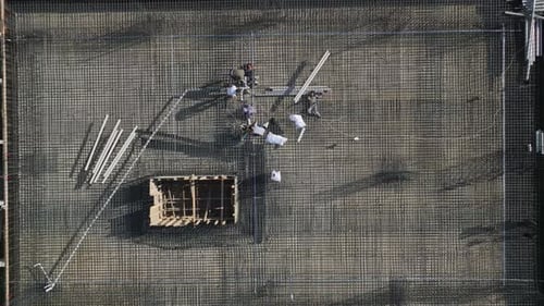 Aerial View of Construction Workers Building Rebar Foundation