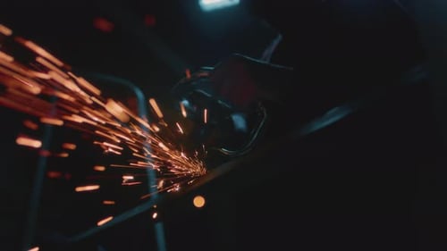 Welder at Work in Industry Cutting Slow Motion Lots of Sparks in Factory Man Cuts Metal with Angle