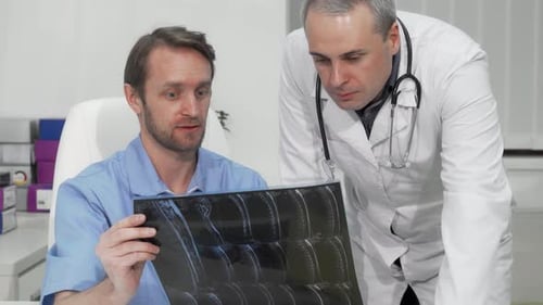 Doctors Examining Medical Scans in Office Setting