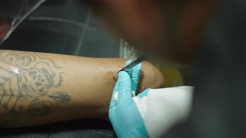 Close Up of a Bamboo Needle Tattoing in Arm