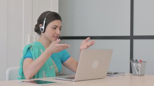 Young Indian Woman with Headset Talking with Customers Online in Call Center