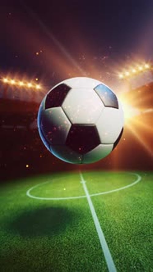 Football rotating against bright stadium sun flare.