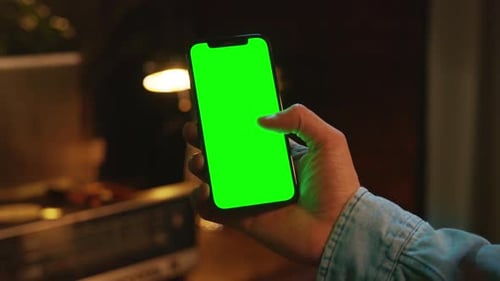 Close Up Mock Up Phone with Vertical Green Screen Hands Using Typing on Smartphone Indoors Social