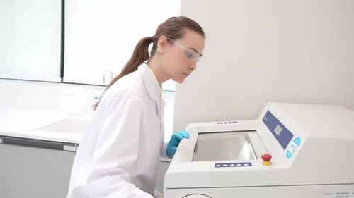 Focused Woman Scientist Works in Bright Modern Laboratory