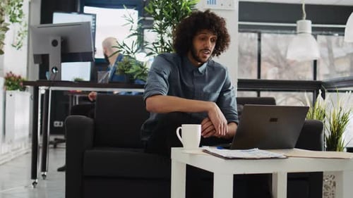 Young Man on Video Call in Modern Office