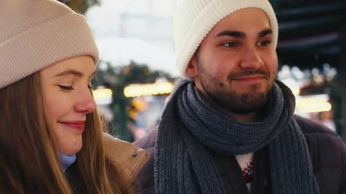 Close up of caucasian couple having fun on Christmas market